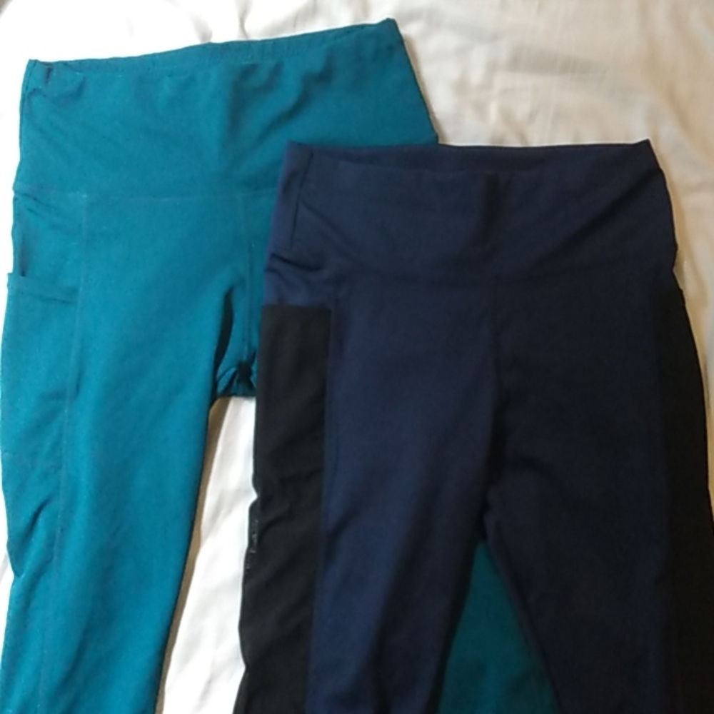 Two pairs of athletic leggings, unknown brand. Both size Medium.